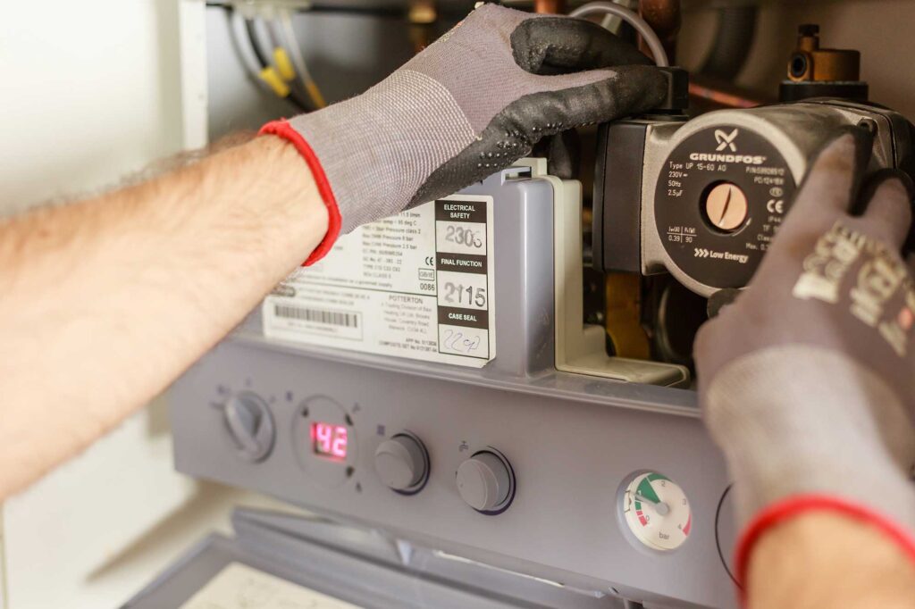 Plumber fixing a gas boiler